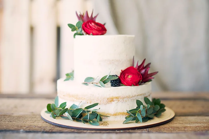 A white celebration cake decorated with roses