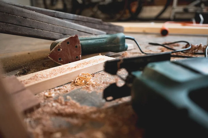 A power saw cutting into a timber board