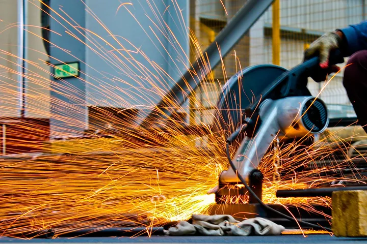Sparks flying from metal being ground in a workshop