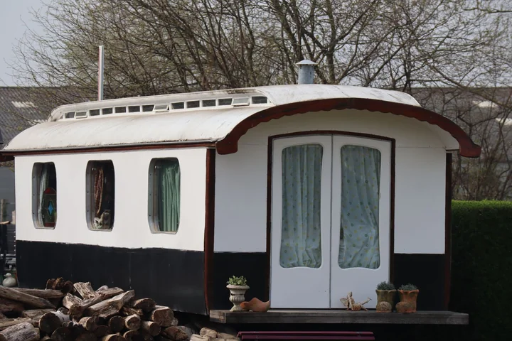 A traditional shepherd's hut with a curved roof