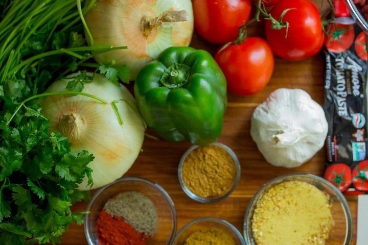 Fresh vegetables, garlic and spices on a board