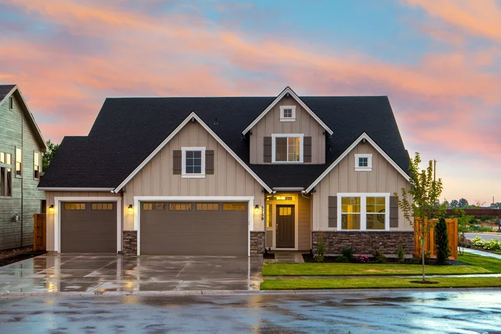 A suburban family home lit up in the evening