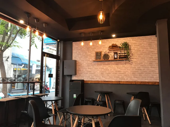 An empty cafe interior with tables and stools
