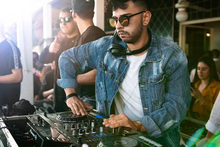A DJ playing to a crowd behind the decks