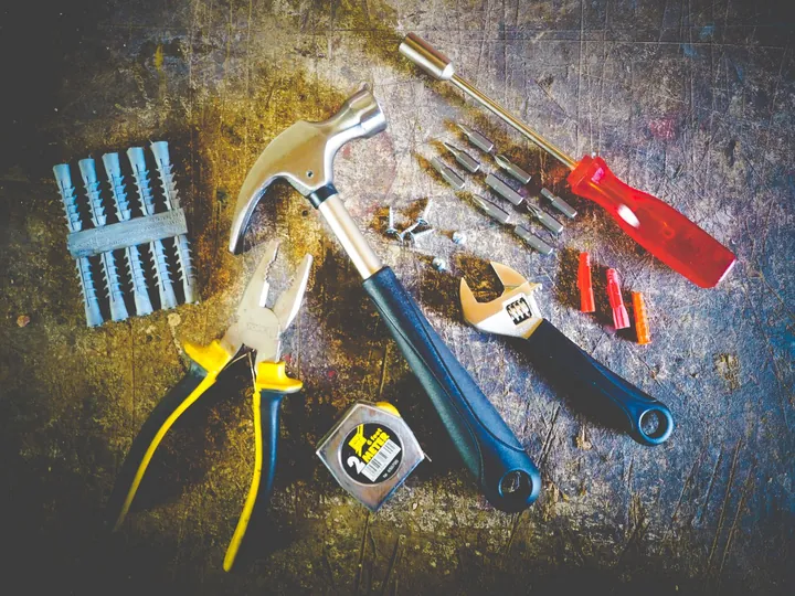 Hand tools laid out on a dark surface