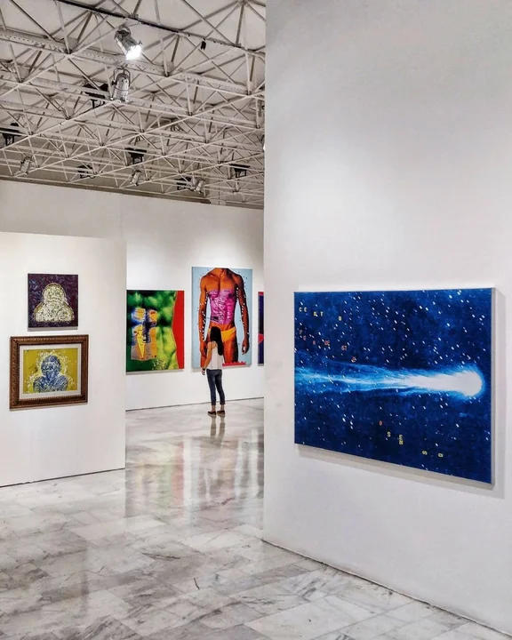 A modern gallery interior with artworks on white walls
