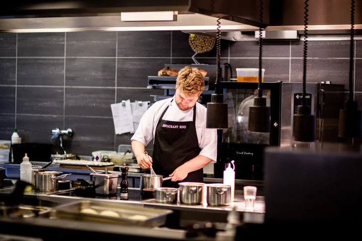 A chef working alone in a professional kitchen