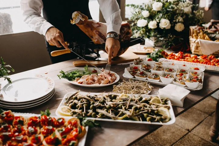 A catering buffet being served onto plates