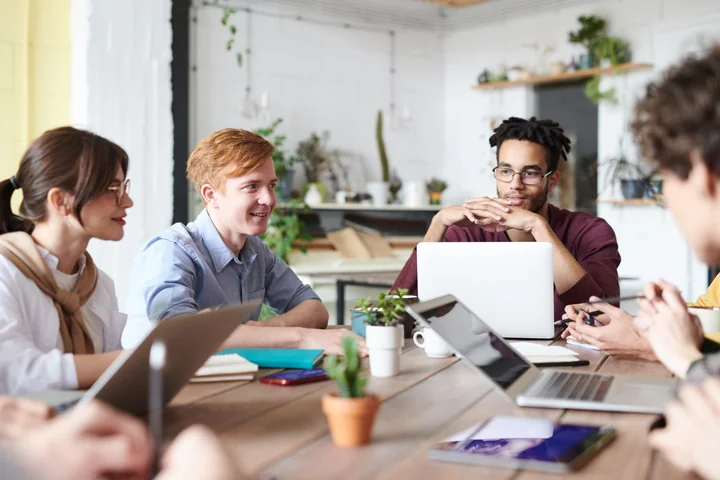 A group meeting around a table in a bright office
