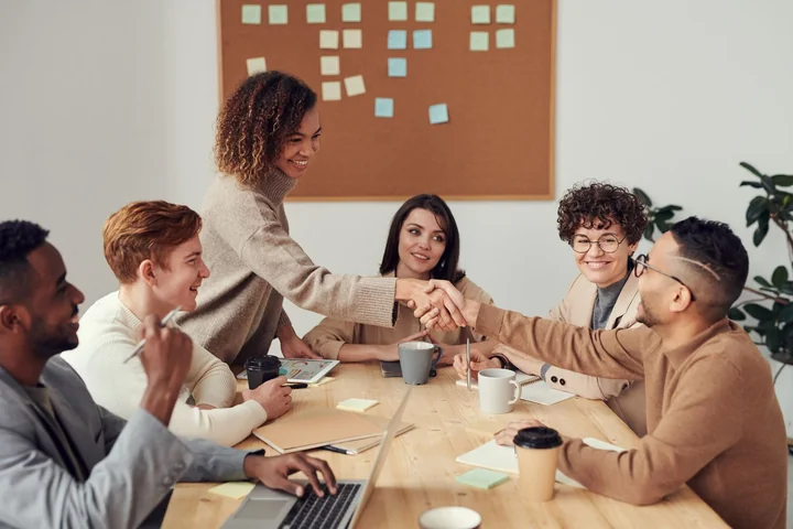 An office meeting in front of a board of sticky notes