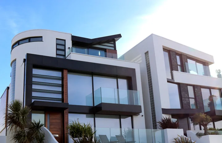 A modern white apartment building against blue sky