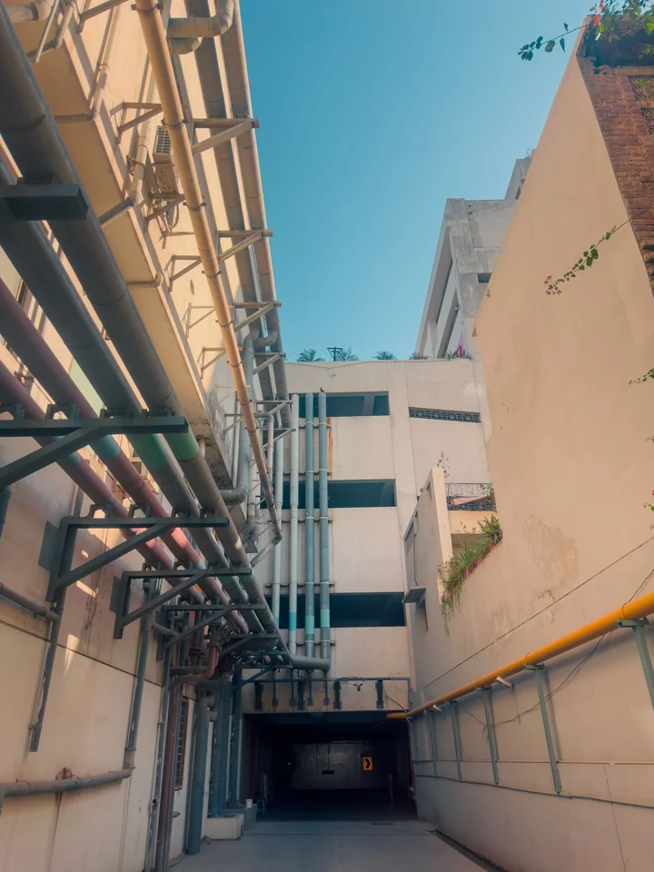 A narrow sunlit street between apartment buildings