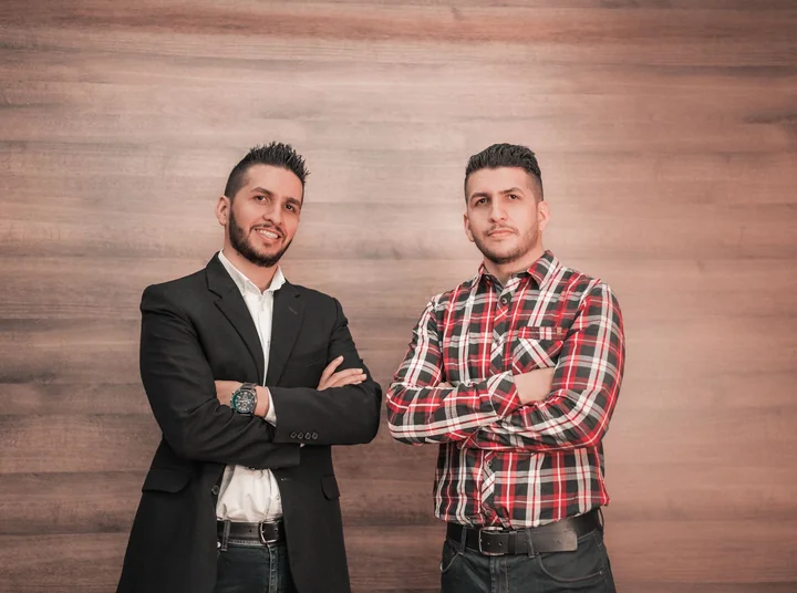 Two men standing together in a workshop
