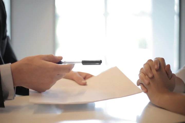 A document being passed across a table