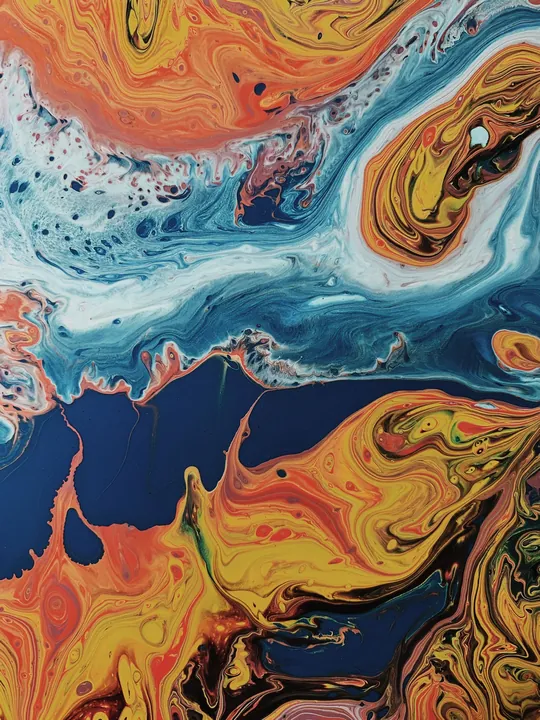 Swirled marbled paint in blues and oranges