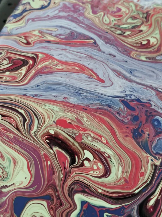 Swirled marbled paint in pink and grey