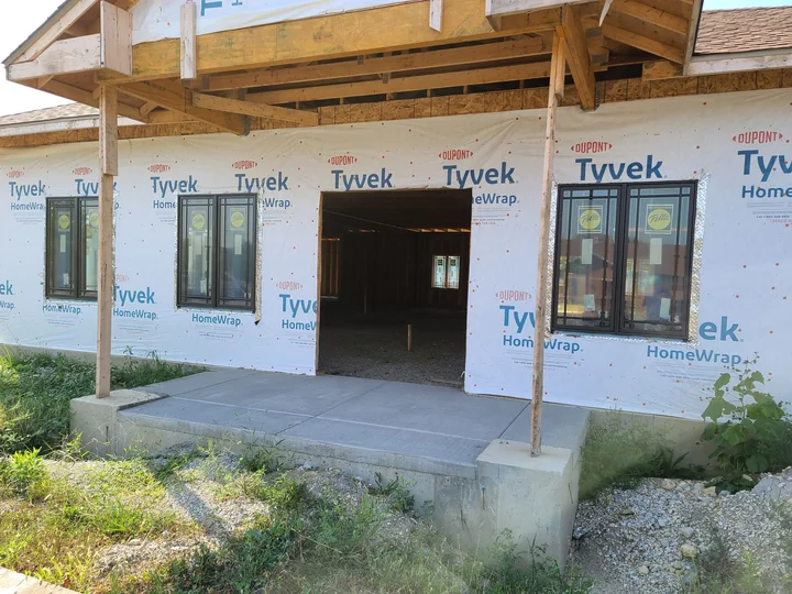 A house under construction wrapped in building membrane