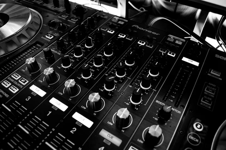 A DJ mixing desk photographed in low light