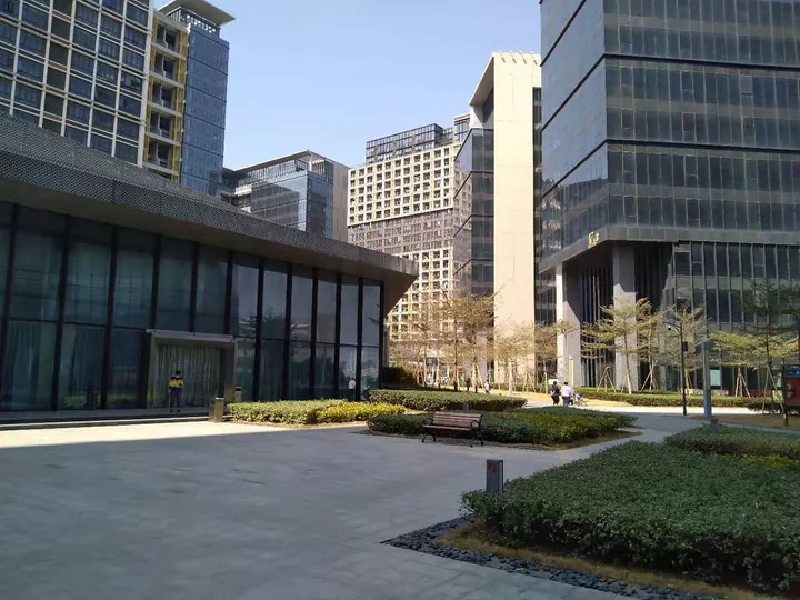 A modern office block behind landscaped grounds