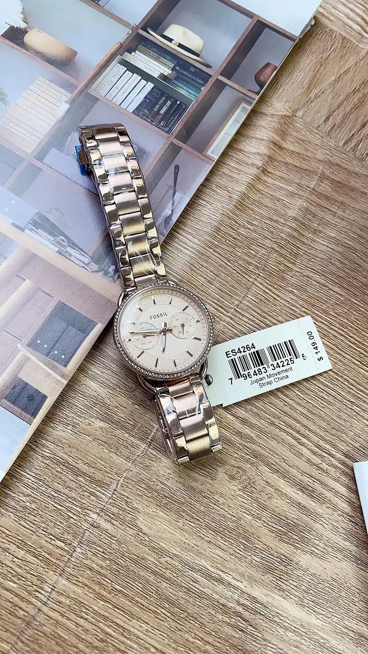 A wristwatch with a price tag resting on a table