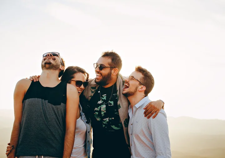 Four friends standing together outdoors