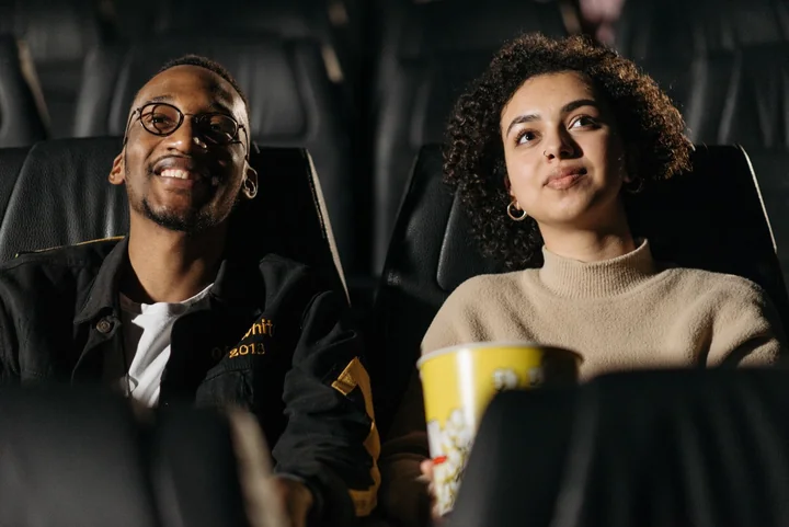 A couple watching a film with popcorn