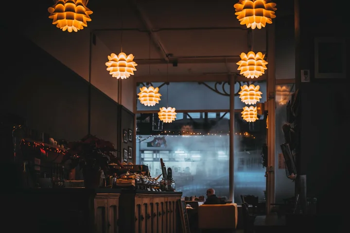 A restaurant interior lit by hanging pendant lamps